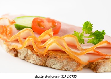 Detail Of Open Faced Ham Sandwich On White Background