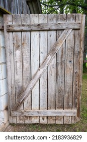 Detail of a open wooden door with big wooden lock in an old shack.