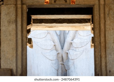 Detail of ornate carvings of leaves on an ancient statue in Shravanabelagola in Karnataka, India. - Powered by Shutterstock