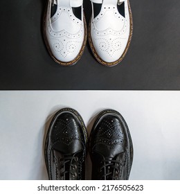 Detail Of A Pair Of Classic Black And White Brogue Wingtip Shoes For Men And Women On A Black And White Background