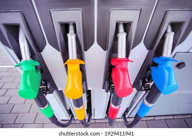 Detail Of A Petrol Pump In A Petrol Station.Close Up On Fuel Nozzle In Oil Dispenser With Gasoline And Diesel In Service Gas Station. Blue, Green, Red, Golden Colors