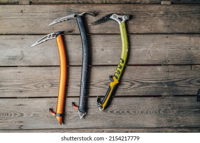 Detail photo of different ice climbing tools. Ice climbing gear, ice axe on a wooden background. Alpinist or mountaineer climbing equipment. - Powered by Shutterstock