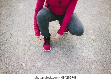 Detail Of Pregnant Sporty Woman Lacing Sneakers Before Jogging Or Training Outdoor. Sport And Healthy Lifestyle During Pregnancy Concept