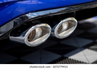 Detail of premium clean chrome car exhaust pipes. Close up. Logo retouched.