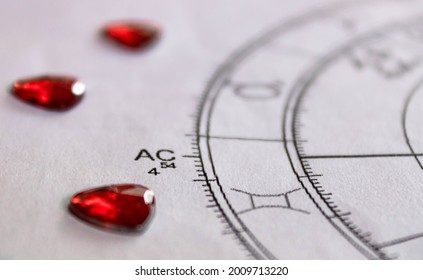 Detail of printed astrology chart with with red heart shaped sequins, ascendant sign - Shutterstock ID 2009713220