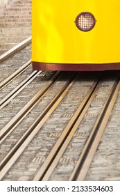 Detail of rails and front section with headlamp of yellow tram (copy space) - Tracks on Street with Passenger Car 