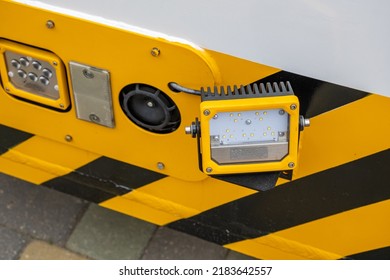 Detail Of The Rear Of A New Utility Truck. Taillights, Electrical Connectors, Plastic Mudguards, Wheels And Rims. Red Brake Lights And Orange Turn Signals. Road Safety