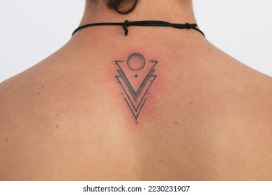 Detail of recent tattoo finished with the red skin irritation, minimalist design with dots triangles and circles - Shutterstock ID 2230231907