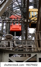 Detail Of A Red And Yellow Elevator Of The Eiffel Tower In Paris, France. Useful File For Your Brochure, Site, Flyer Or Article About French Culture, Paris And Eiffel Tower.