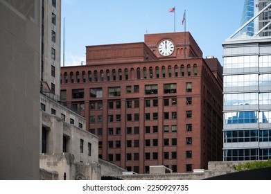 Detail of a reddish brick building with a clock in the city of Chicago - Powered by Shutterstock