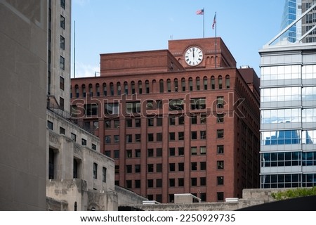Detail of a reddish brick building with a clock in the city of Chicago