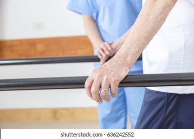 Detail Of Rehab Gym. Elderly People At The Bar.