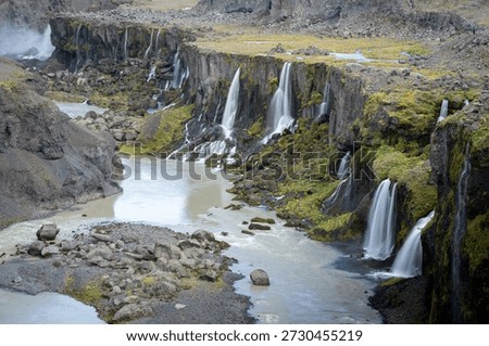 Detail of river valley with multiple massive waterfalls streaming into it, Highlands, Iceland
