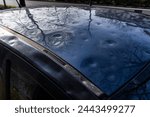 detail of the roof of the car damaged by hail. damage from natural disaster. hail damage