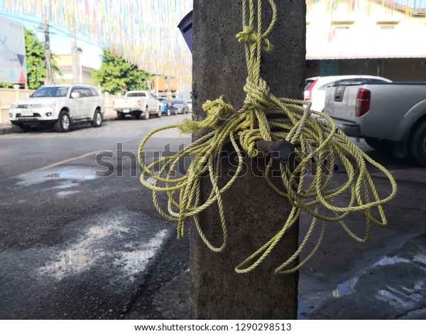 Detail of rope\
tied to General electric\
pole.