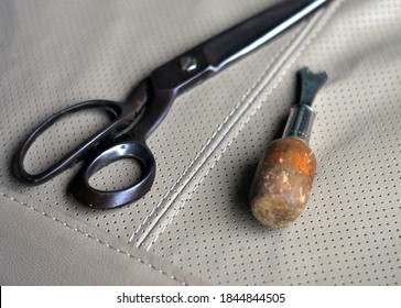 Detail Of Scissors And Staple Remover On A Vinyl, Representing The Craft Of Upholstery