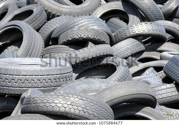 Detail\
of a scrap tire dump with different types of\
tires