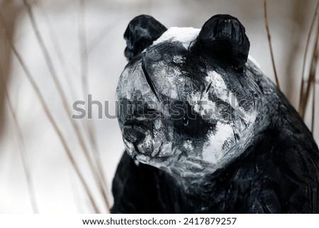 Detail of a sculpture representing the head of a panda in winter