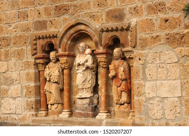 Detail Of Sculptures Of The Church Of Santa María De Piasca. They Represent Saint Peter With The Keys, Saint Paul With A Book And The Virgin Mary With The Child Jesus.