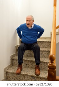 Detail Of A Senior Man With Backache Because Of Falling On Stairs Of Home