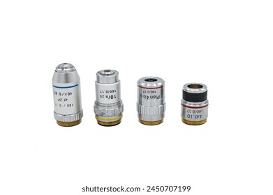 Detail of a set of four microscope lenses on a white background, there are approach and immersion lenses - Powered by Shutterstock - Get 15% off with code: PIKWIZARD15