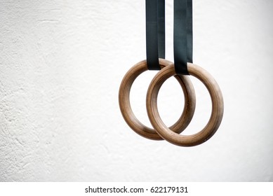 Woman holding gymnastic rings in gym