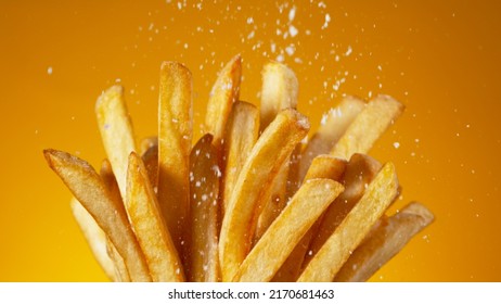 Detail Shot of adding Salt on French Fries, Close-up.