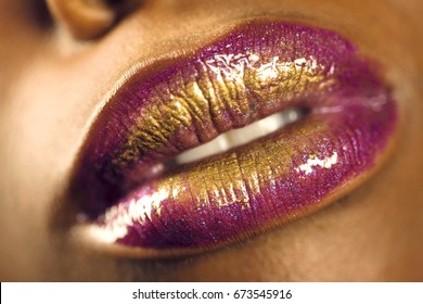 Detail Shot Of An African American Woman's Purple And Golden Lips