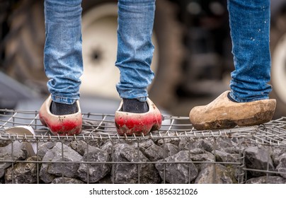 Detail shot of farmers legs in clogs and jeans during protests in The Hague
