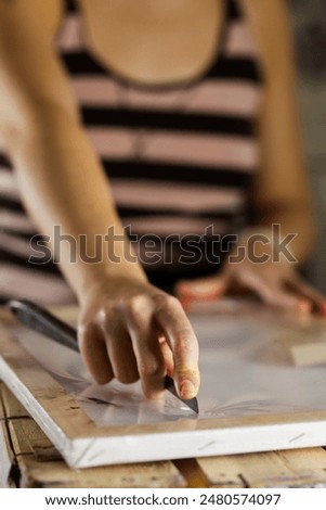 Similar – Image, Stock Photo Woman carefully cutting paper design in studio