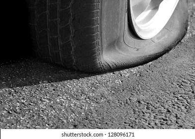 Detail Shot of a Flat Tire on a Car