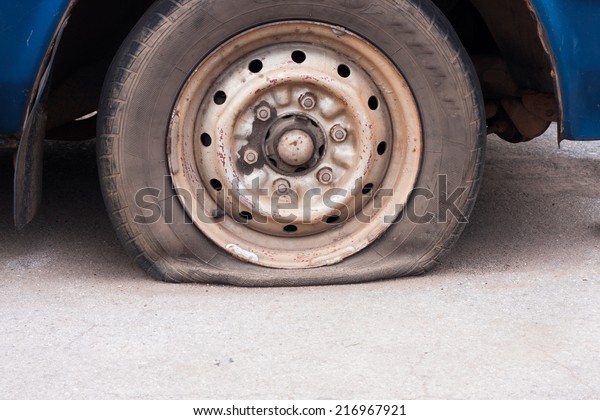 Detail Shot of a Flat Tire
on a Car