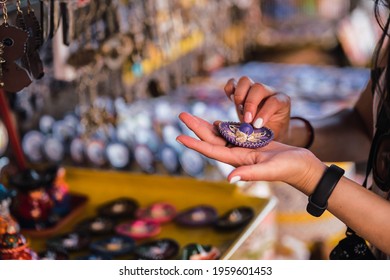 Detail Shot Of Hand Holding Mexican Crafts. Has A Smart Watch