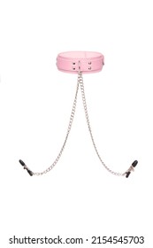 Detail shot of a pink leather choker with a metal buckle, rivets, chains and with nipple clamps. The stylish adjustable collar with nipple clips is isolated on the white background.