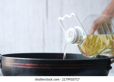 Detail Shot Of Pouring Vegetable Oil Into Frying Pan.