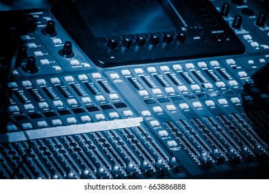 Detail Shot Of Recording Studio Mixing Desk In Blue Tone.