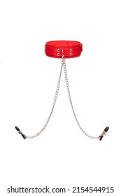 Detail shot of a red leather choker with a metal buckle, rivets, chains and with nipple clamps. The stylish adjustable collar with nipple clips is isolated on the white background.