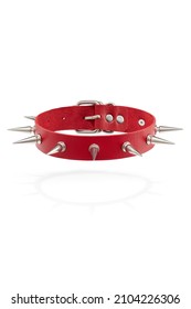 Detail shot of red leather collar with steel sharp thorns and metal buckle. Stylish adjustable choker is isolated on the white background.  