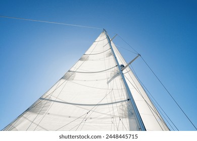 Detail shot of a sailboat underway with full sails, mainsail and foresail  on a sunny day - Powered by Shutterstock