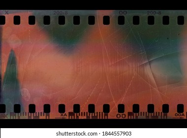 Detail Shot Of Short 35mm Film Snip Or Strip On Black Background With Scratches And Fingerprint Texture.