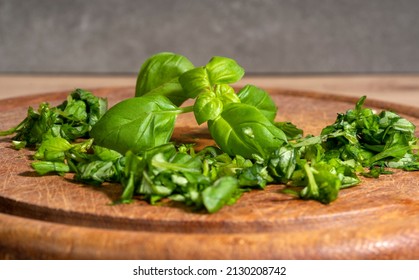 Detail Shot Of Some Chopped Basil On Wooden Cutting Board