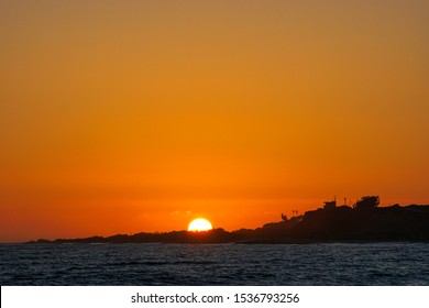 Detail Shot Of The Sunset Sunball As It Dips Behind The Beach Head Near The Lifeguard Tower In Lower Trestles In San Clemente, Southern California.