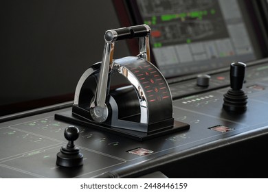 Detail shot of the throttle controls, radar and ship's systems in the bridge of a modern superyacht, with dark leader interior