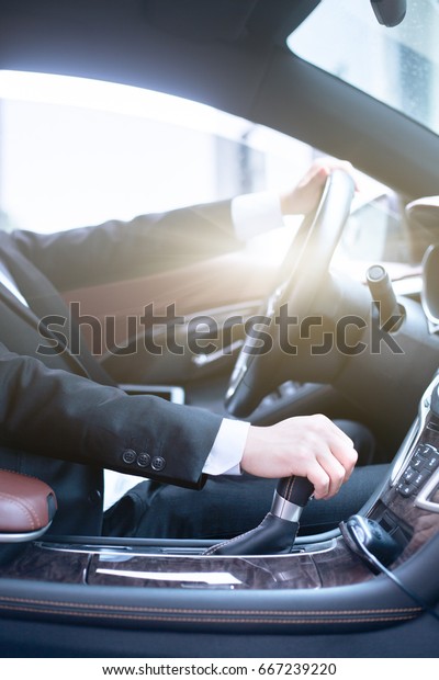 detail shot of\
young businessman driving his\
car.