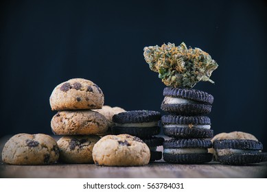 Detail Of Single Cannabis Nug Over Infused Chocolate Chips Cookies - Medical Marijuana Edibles Concept