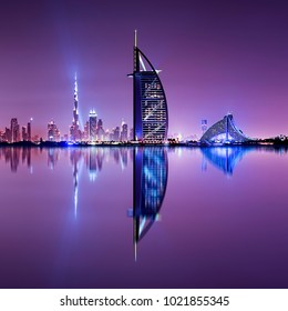 Detail of skyscraper reflection. Beautiful skyline scene in Dubai. Multiple highest buildings during night. The Palm island, United Arab Emirates.