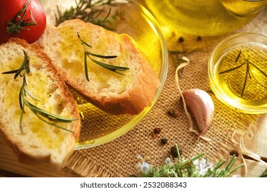 Detail of a slices of bread seasoned with rosemary-essenced oil on a glass plate with rosemary sprigs on rustic table. Top view. - Powered by Shutterstock