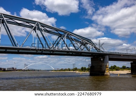 Detail of Snelbinder bridge seen from the water. River Maas waterfront shore of historic Hanseatic city Nijmegen