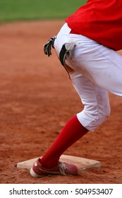 Detail Of Softball (baseball) Player With Gloves In Back Pocket Of Trousers, Standing On Base