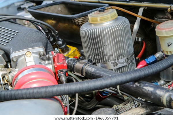 A detail of the sports car engine. It is a\
historic rallye car from the past.\
